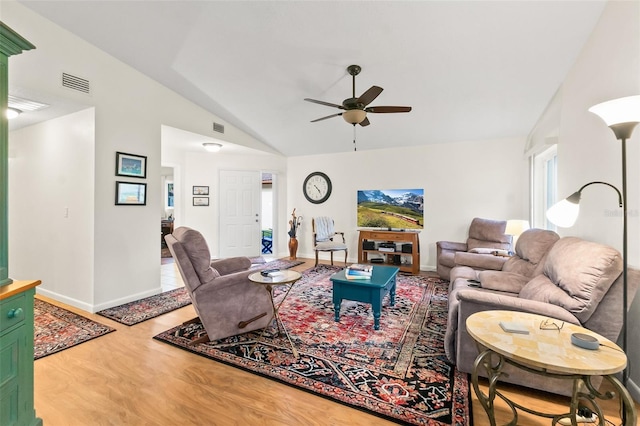 living room with lofted ceiling, hardwood / wood-style flooring, and ceiling fan