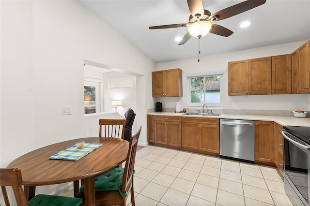 kitchen with light tile patterned flooring, lofted ceiling, sink, ceiling fan, and stainless steel appliances