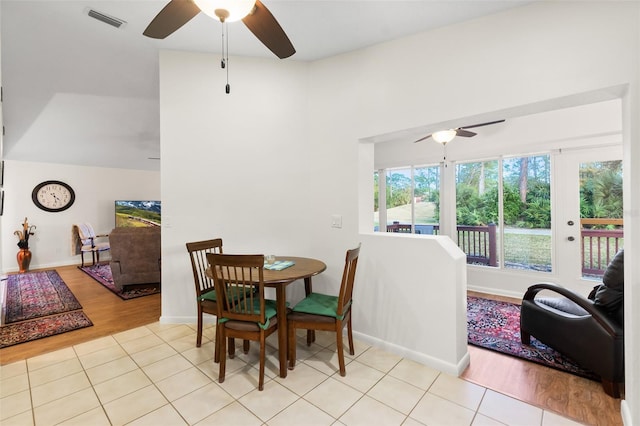 tiled dining area featuring ceiling fan