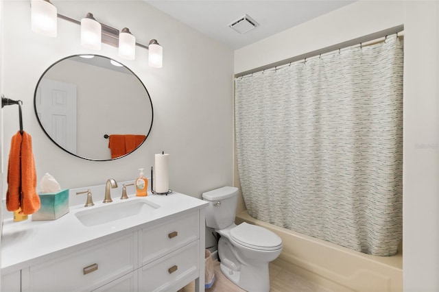 full bathroom featuring shower / tub combo with curtain, vanity, and toilet