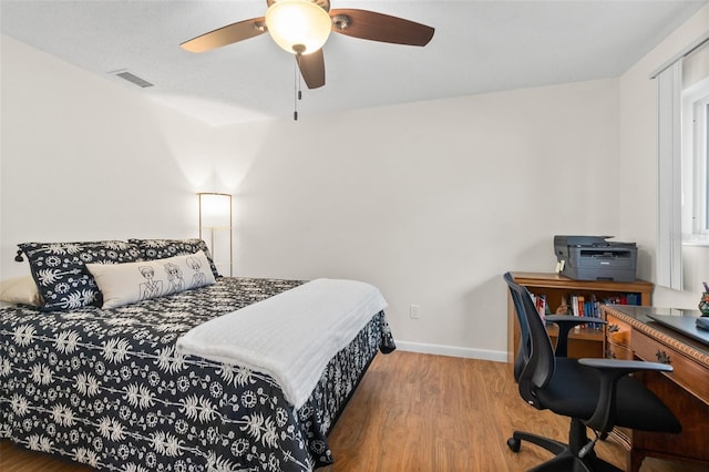 bedroom with hardwood / wood-style flooring and ceiling fan