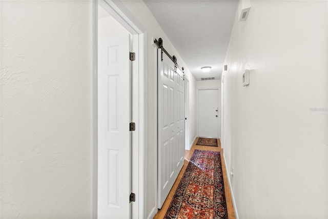 corridor featuring a barn door