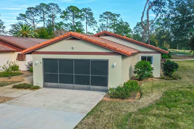 exterior space featuring a garage and a yard