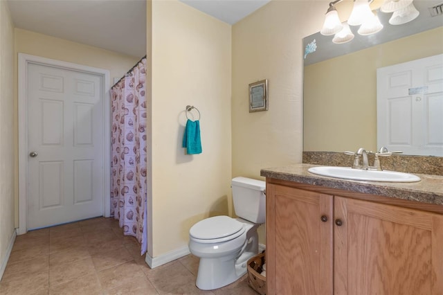 bathroom featuring vanity, tile patterned floors, and toilet