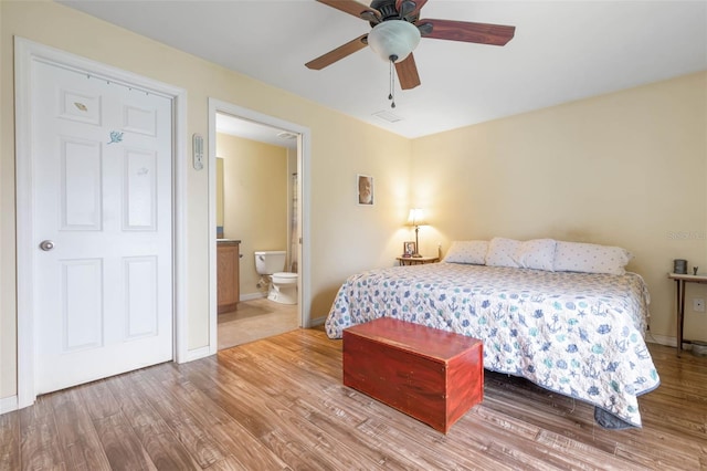 bedroom featuring hardwood / wood-style flooring and ensuite bathroom