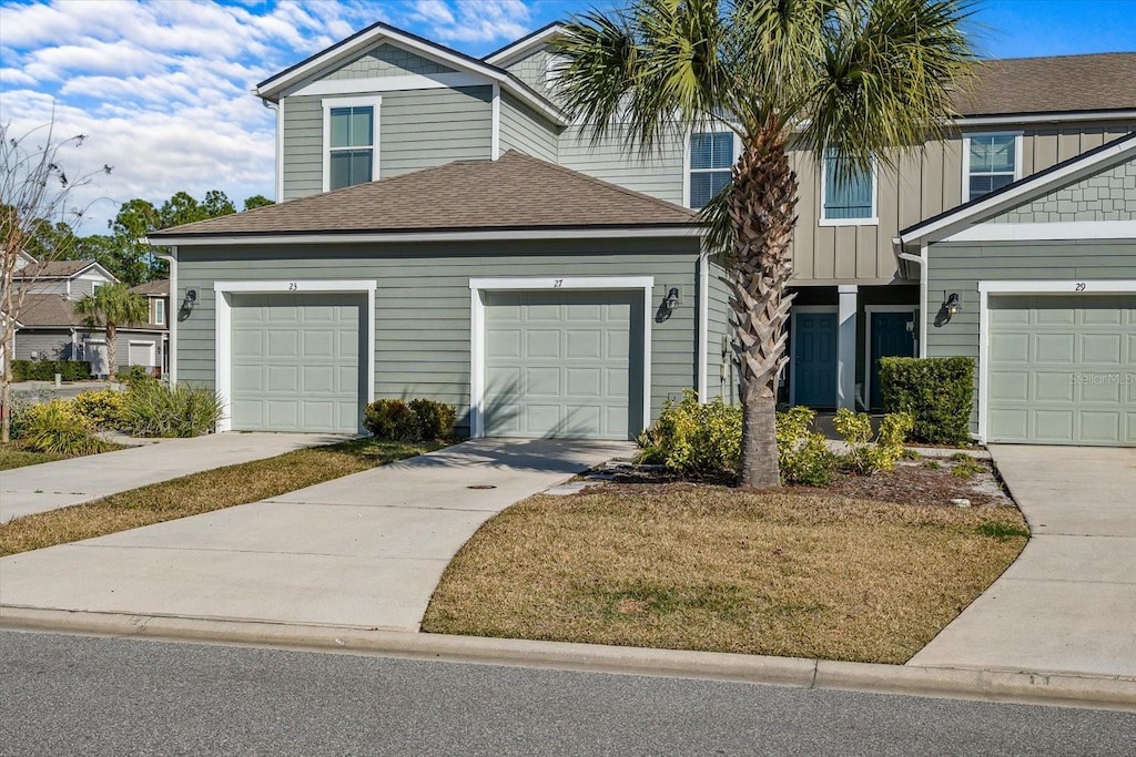 view of front of property with a garage and a front lawn