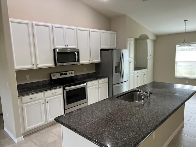 kitchen with white cabinetry, appliances with stainless steel finishes, and a center island with sink