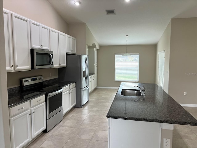 kitchen with stainless steel appliances, sink, and white cabinets