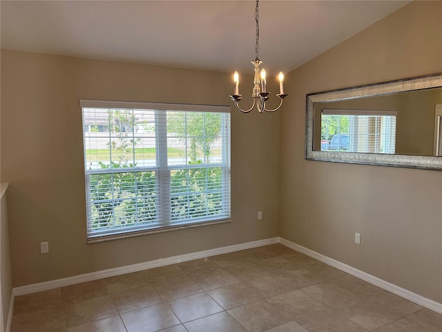 empty room with a notable chandelier and vaulted ceiling