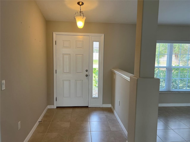 foyer featuring tile patterned floors and a wealth of natural light