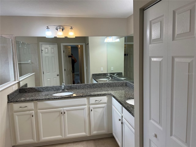 bathroom with vanity, tile patterned flooring, and a shower with door