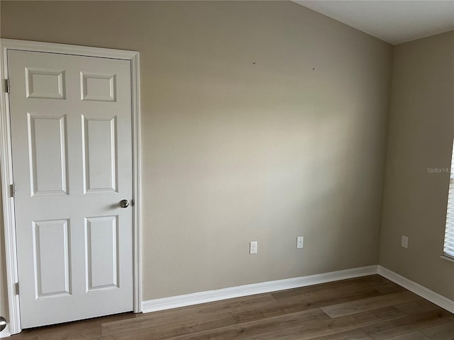 spare room with hardwood / wood-style floors