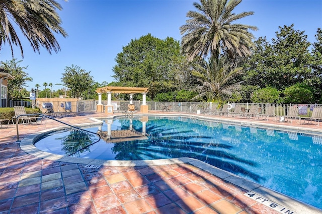 view of swimming pool featuring a patio and a pergola