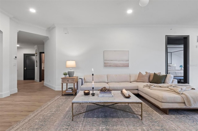 living room featuring hardwood / wood-style flooring and ornamental molding