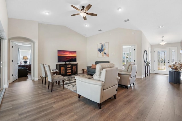 living room with lofted ceiling, dark hardwood / wood-style floors, and ceiling fan