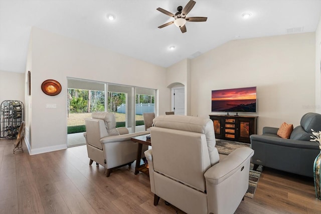 living room featuring hardwood / wood-style flooring, ceiling fan, and vaulted ceiling