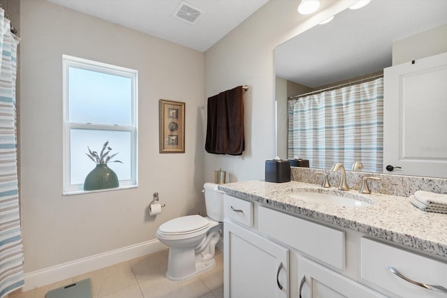 bathroom featuring vanity, tile patterned flooring, and toilet