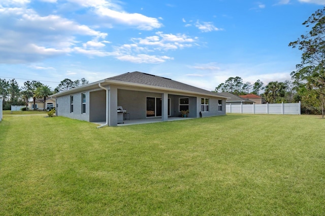 back of property with a patio and a lawn