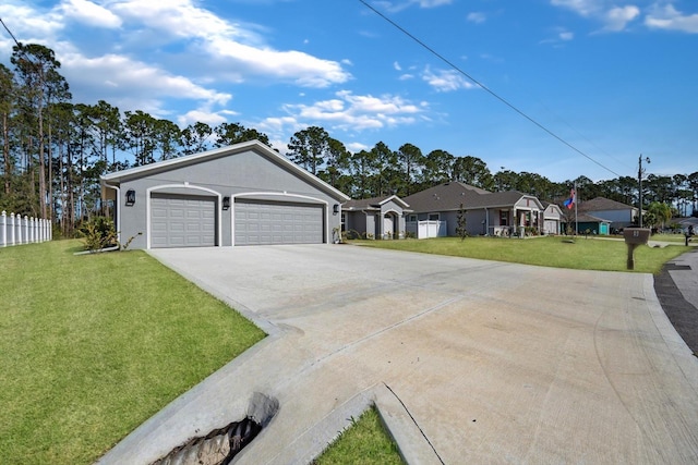 view of front of house featuring a garage and a front lawn