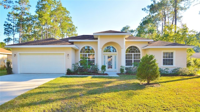 view of front of home featuring a garage and a front lawn