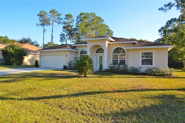 view of front of property with a garage and a front lawn