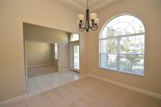 carpeted foyer entrance with a chandelier