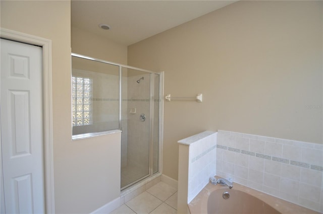 bathroom featuring tile patterned flooring and shower with separate bathtub