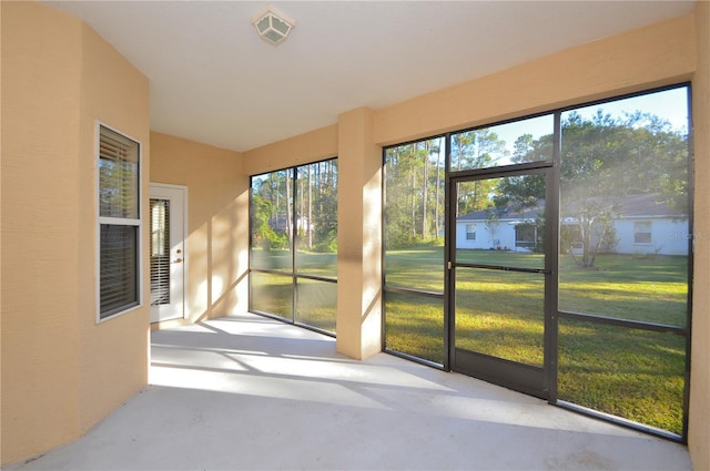 unfurnished sunroom with vaulted ceiling