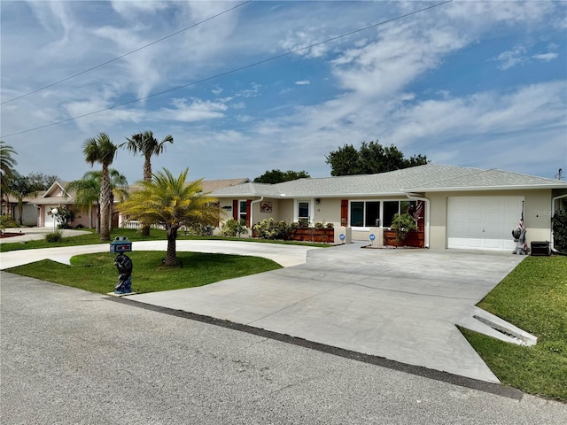 15 Cloverdale Ct S, Palm Coast, FL 32137 - ranch-style house with curved driveway, a front yard, an attached garage, and stucco siding