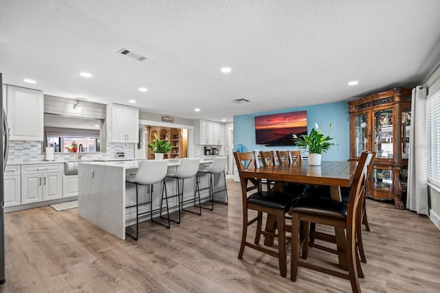 15 Cloverdale Ct S, Palm Coast, FL 32137 - dining room featuring a textured ceiling, light wood-style floors, and recessed lighting