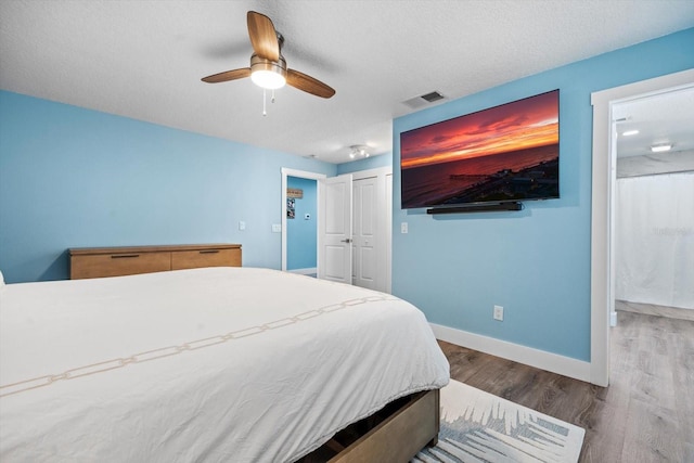 15 Cloverdale Ct S, Palm Coast, FL 32137 - bedroom with wood finished floors, baseboards, a ceiling fan, and a closet