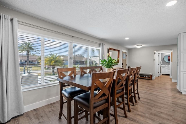 15 Cloverdale Ct S, Palm Coast, FL 32137 - dining space with baseboards, a textured ceiling, light wood finished floors, and recessed lighting