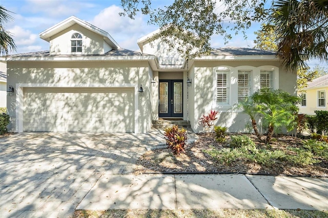 view of front of home with french doors and a garage