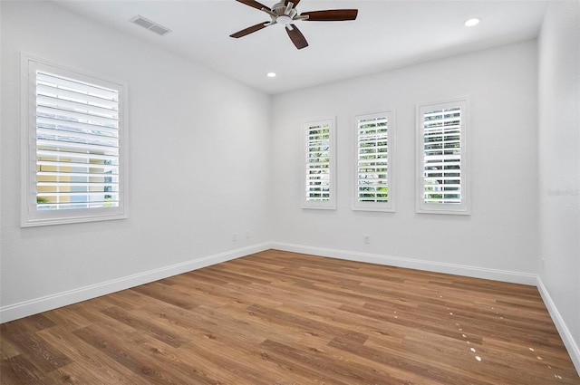 empty room featuring ceiling fan and hardwood / wood-style floors