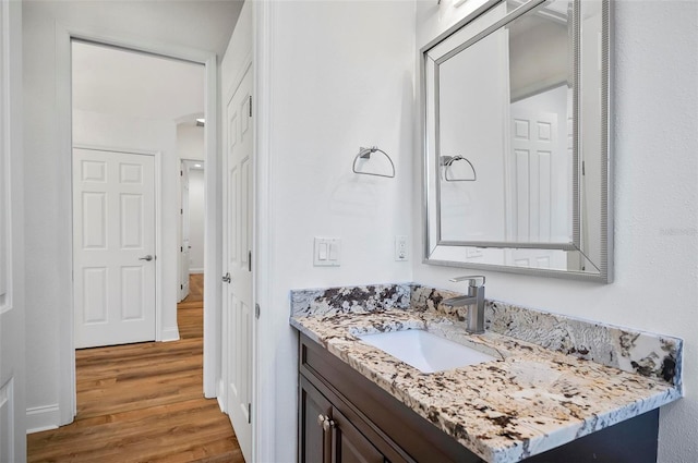 bathroom featuring hardwood / wood-style flooring and vanity