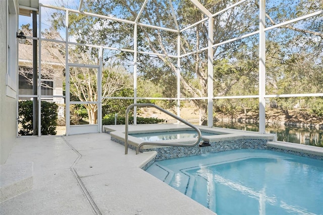 view of swimming pool featuring a water view, an in ground hot tub, a patio area, and glass enclosure