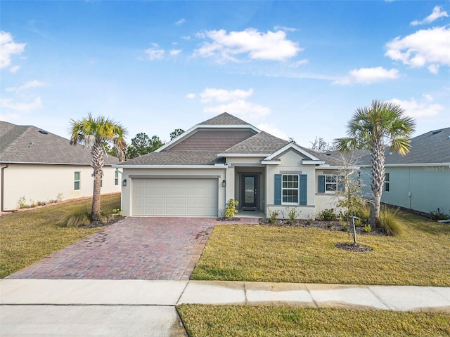 view of front of property with a garage and a front yard