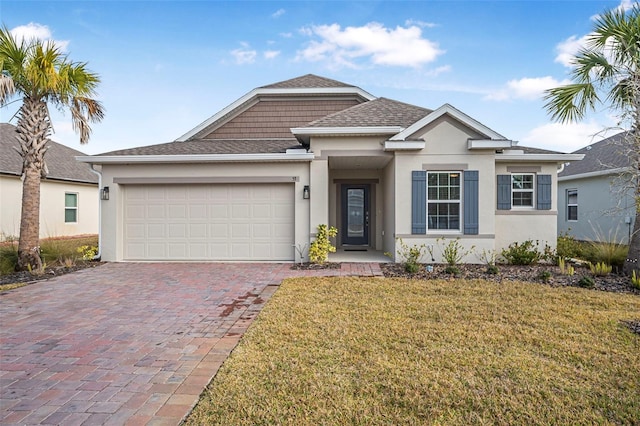 view of front of property with a garage and a front lawn