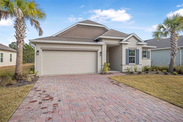 view of front of house featuring a garage and a front lawn