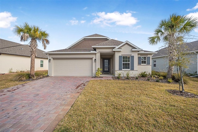 view of front of house featuring a garage and a front lawn