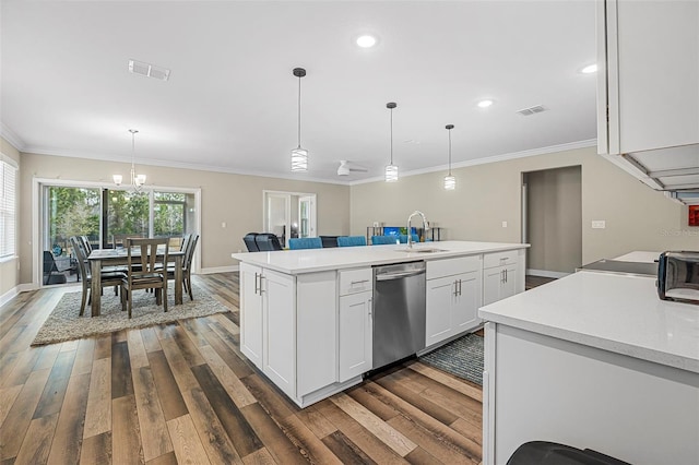 kitchen featuring a kitchen island with sink, decorative light fixtures, stainless steel dishwasher, and white cabinets