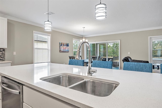 kitchen with crown molding, sink, and decorative light fixtures