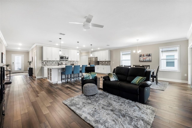 living room featuring ornamental molding, ceiling fan, and dark hardwood / wood-style flooring