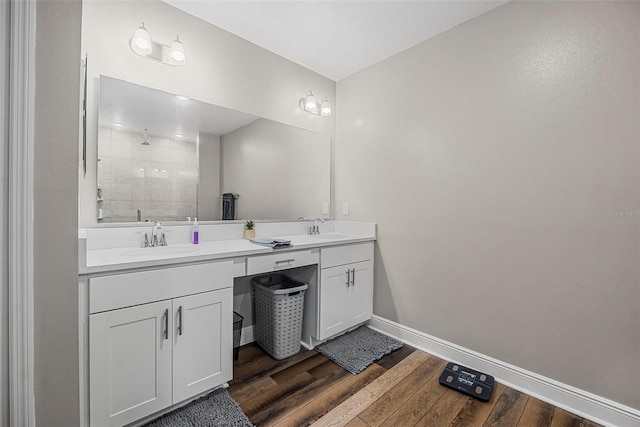 bathroom featuring hardwood / wood-style flooring, vanity, and a shower