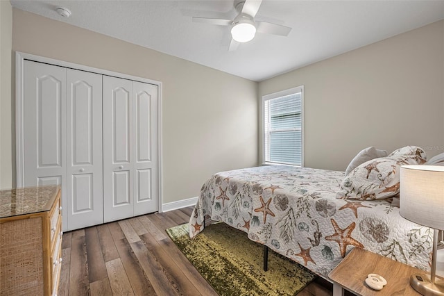 bedroom featuring dark wood-type flooring, a closet, and ceiling fan