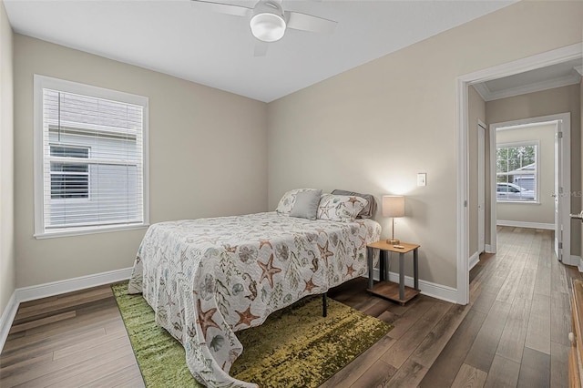 bedroom featuring crown molding, dark hardwood / wood-style floors, and ceiling fan