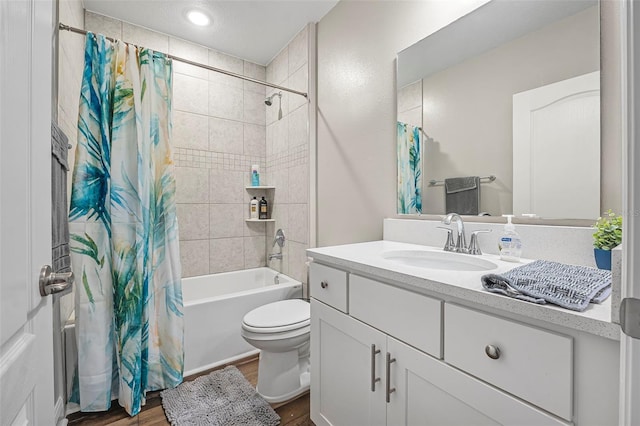 full bathroom with vanity, hardwood / wood-style flooring, toilet, and shower / bath combo with shower curtain