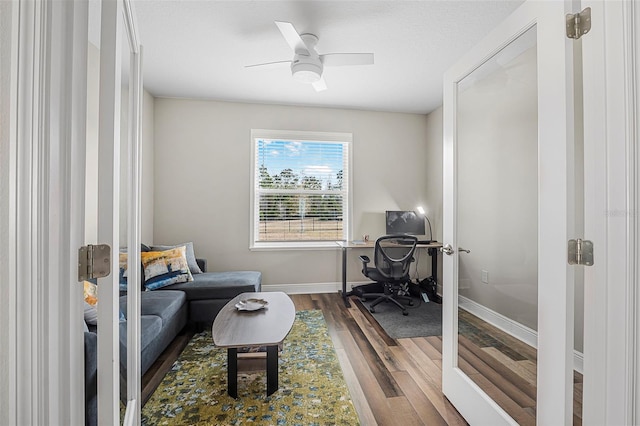 living area featuring hardwood / wood-style floors, a textured ceiling, ceiling fan, and french doors