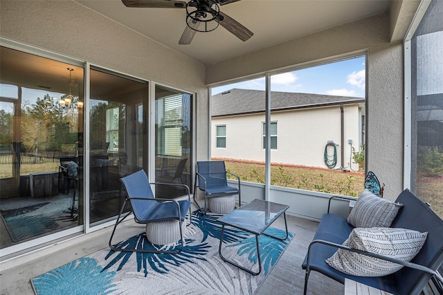 sunroom with ceiling fan with notable chandelier