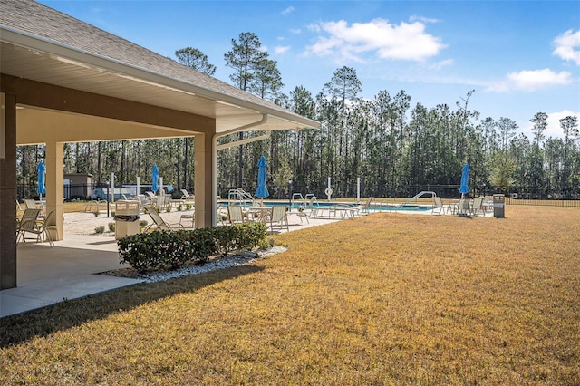 exterior space with a pool, a lawn, and a patio area